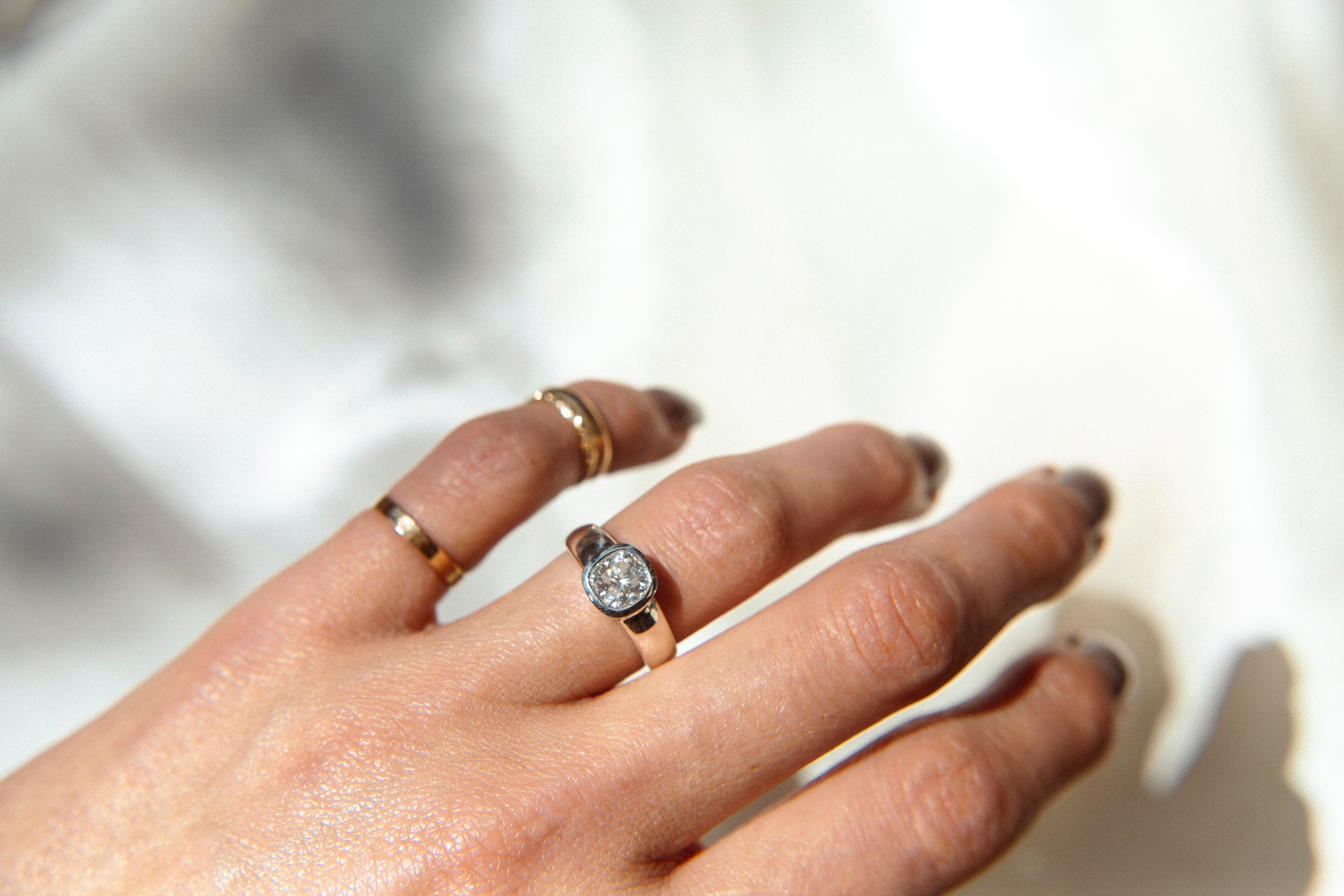 gold ring with a bezel set diamond. This solitaire engagement ring can be made with your desired stone type (Diamond, moissanite, sapphire etc.) and stone shape (Square, Marquis, round, emerald, assher, etc.) and in your choice of metal! (10k yellow or white gold, 14k yellow or white gold, 18k yellow or white gold, platinum and continuum silver.)