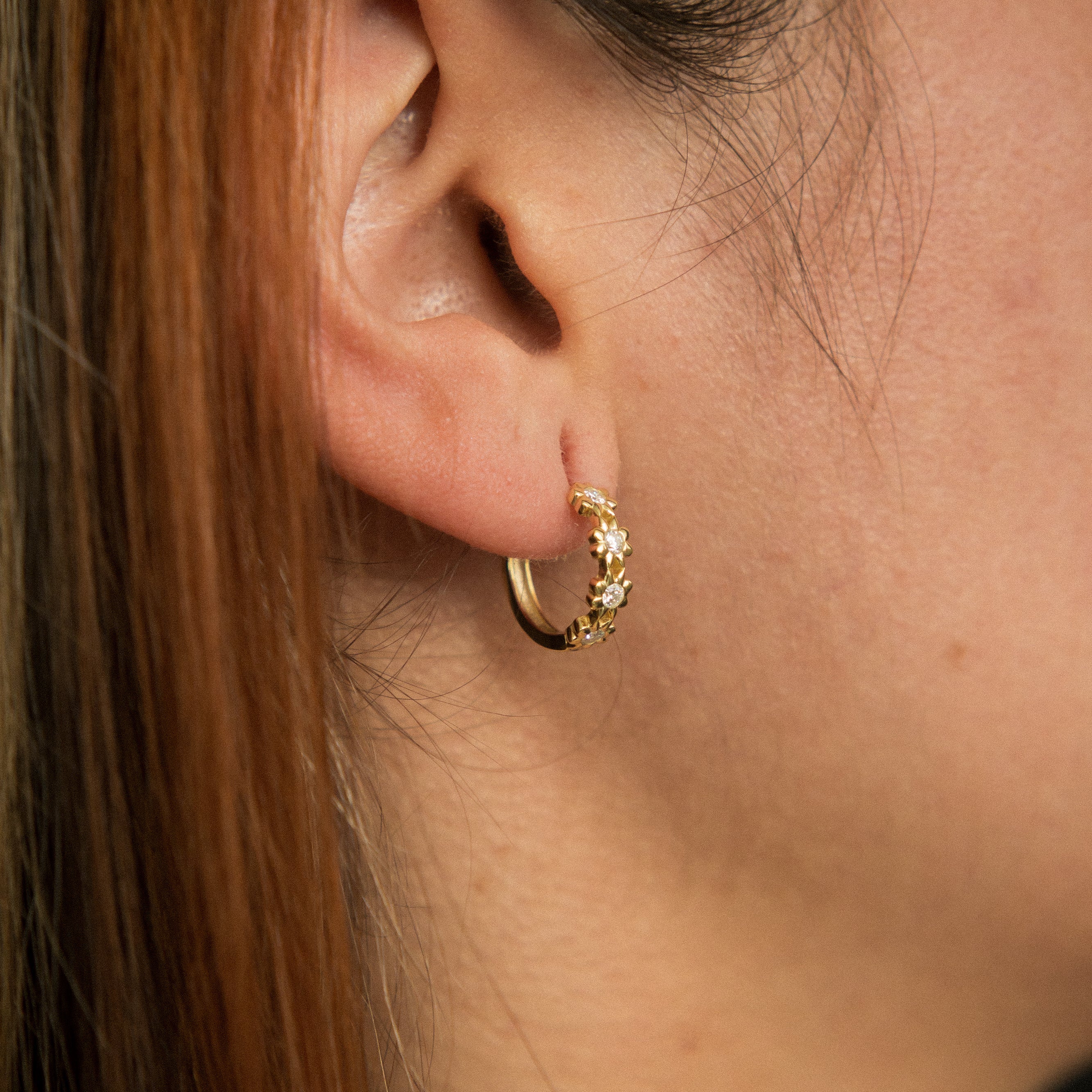Yellow gold vermeil hoops with floral detailing and moissanite centers. Perfect demi fine gift or everyday wear. Sold by Cival in milwaukees bayview