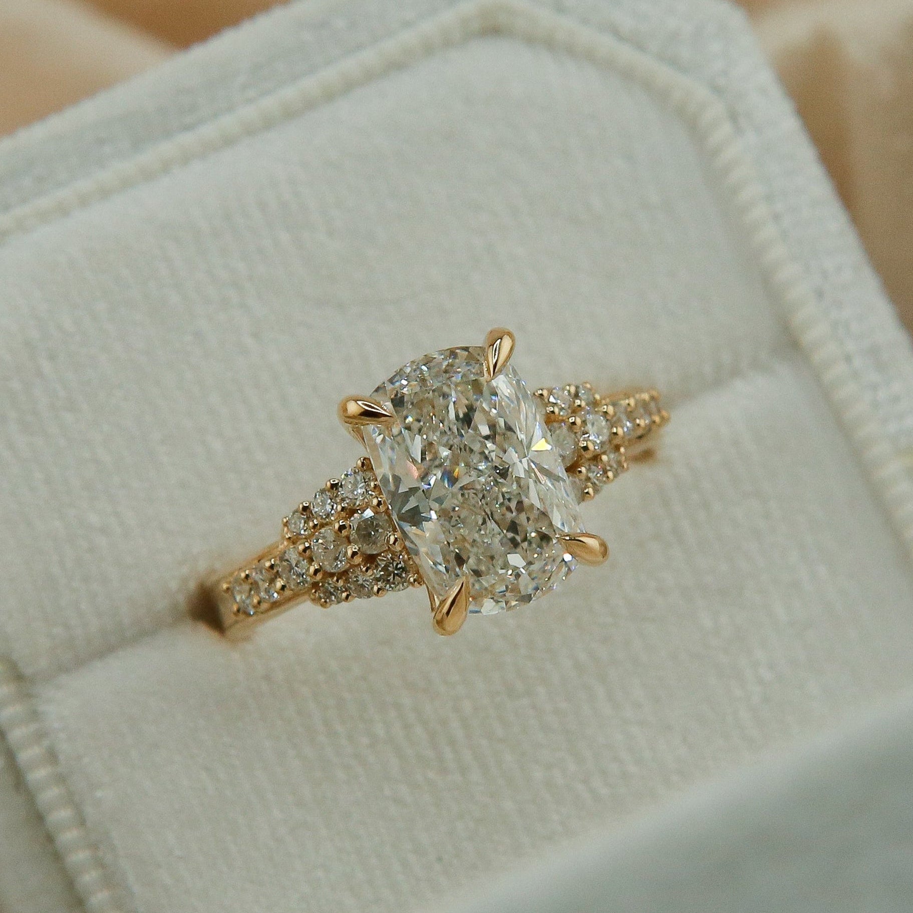 Gold diamond ring in a hexagonal box on beige fabric