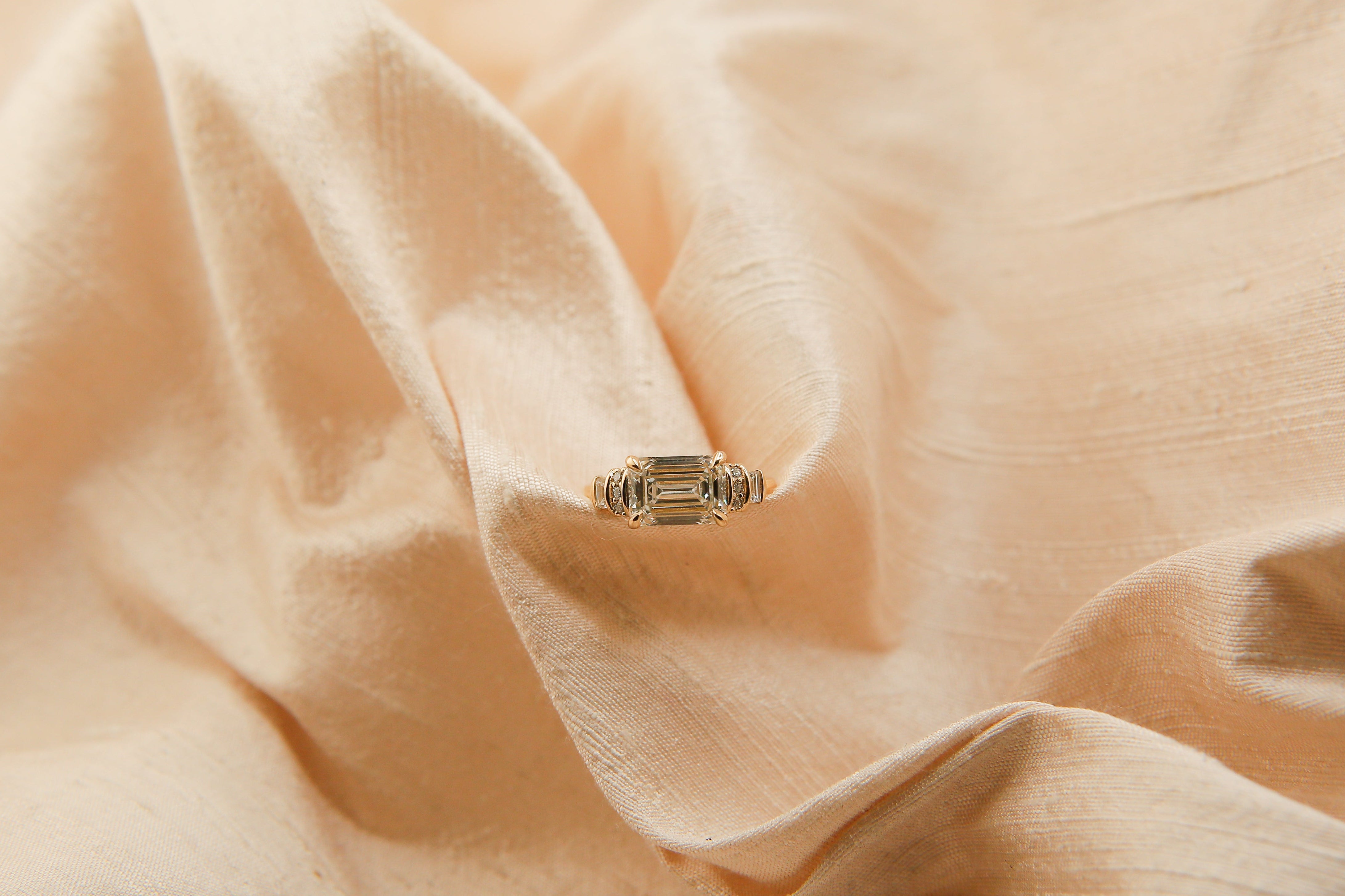 handmade art deco emerald cut east west set diamond engagement ring