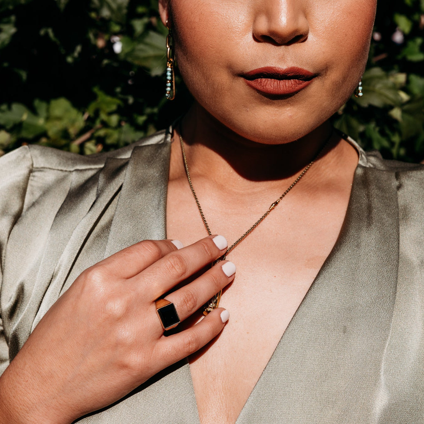 model wearing brass Velma ring with black set stone