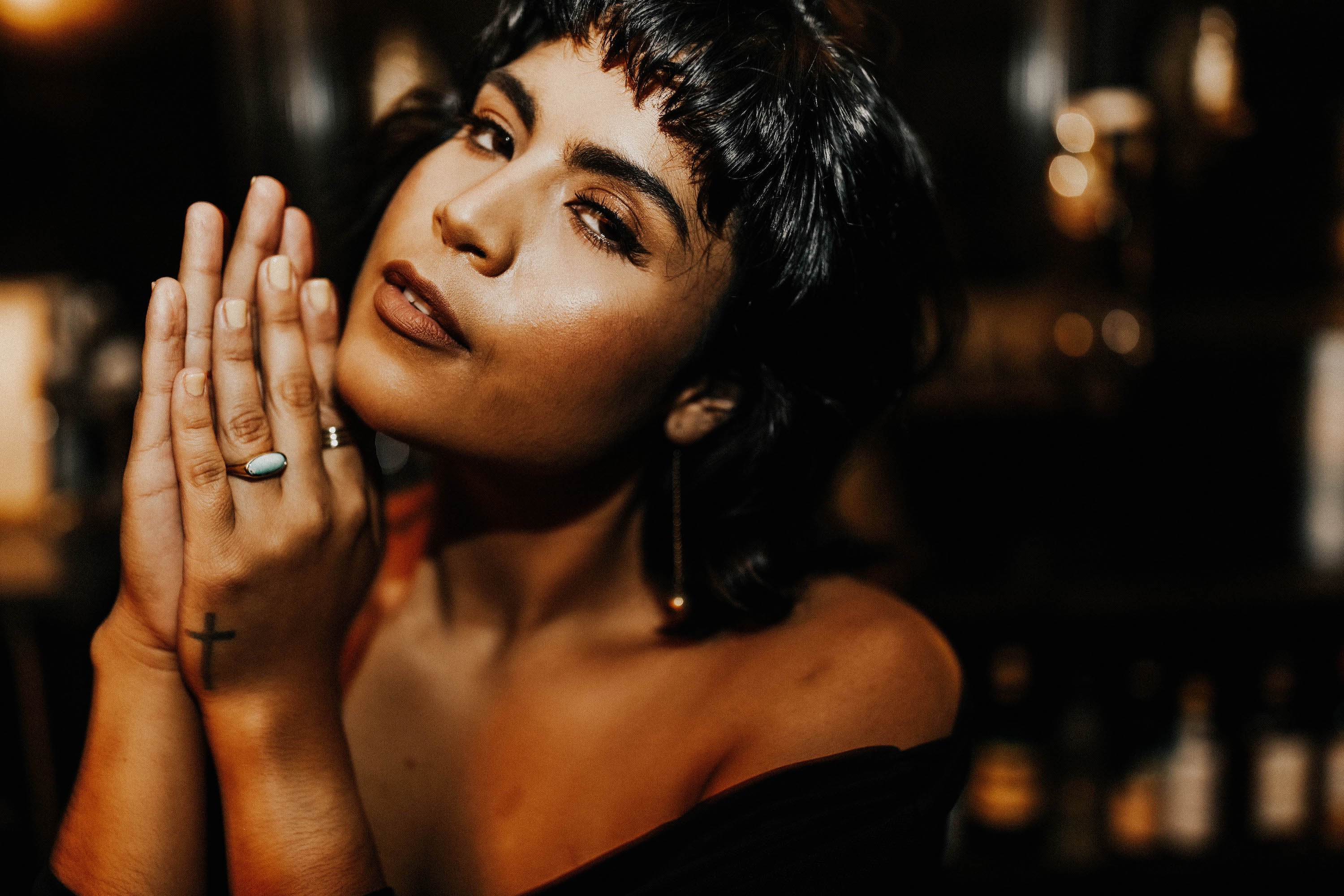woman wearing brass dome ring with blue oval stone