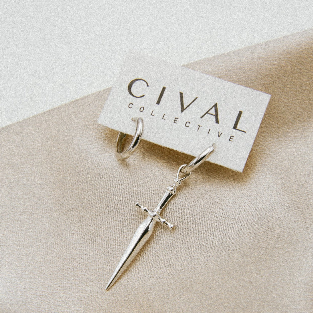 Marceline sterling silver hoops, sword on one hoop