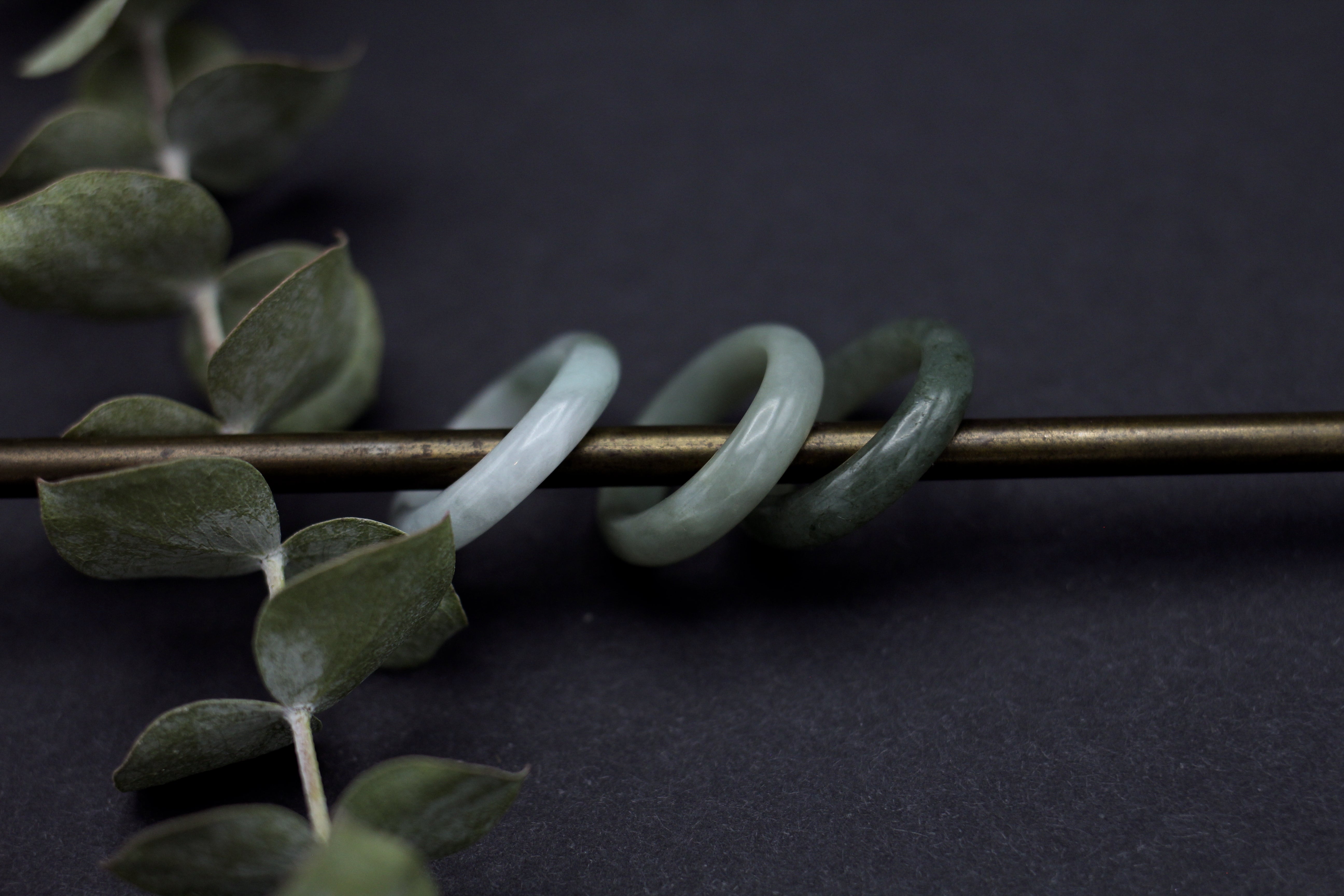 three beautiful jade rings lightest to darkest left to right