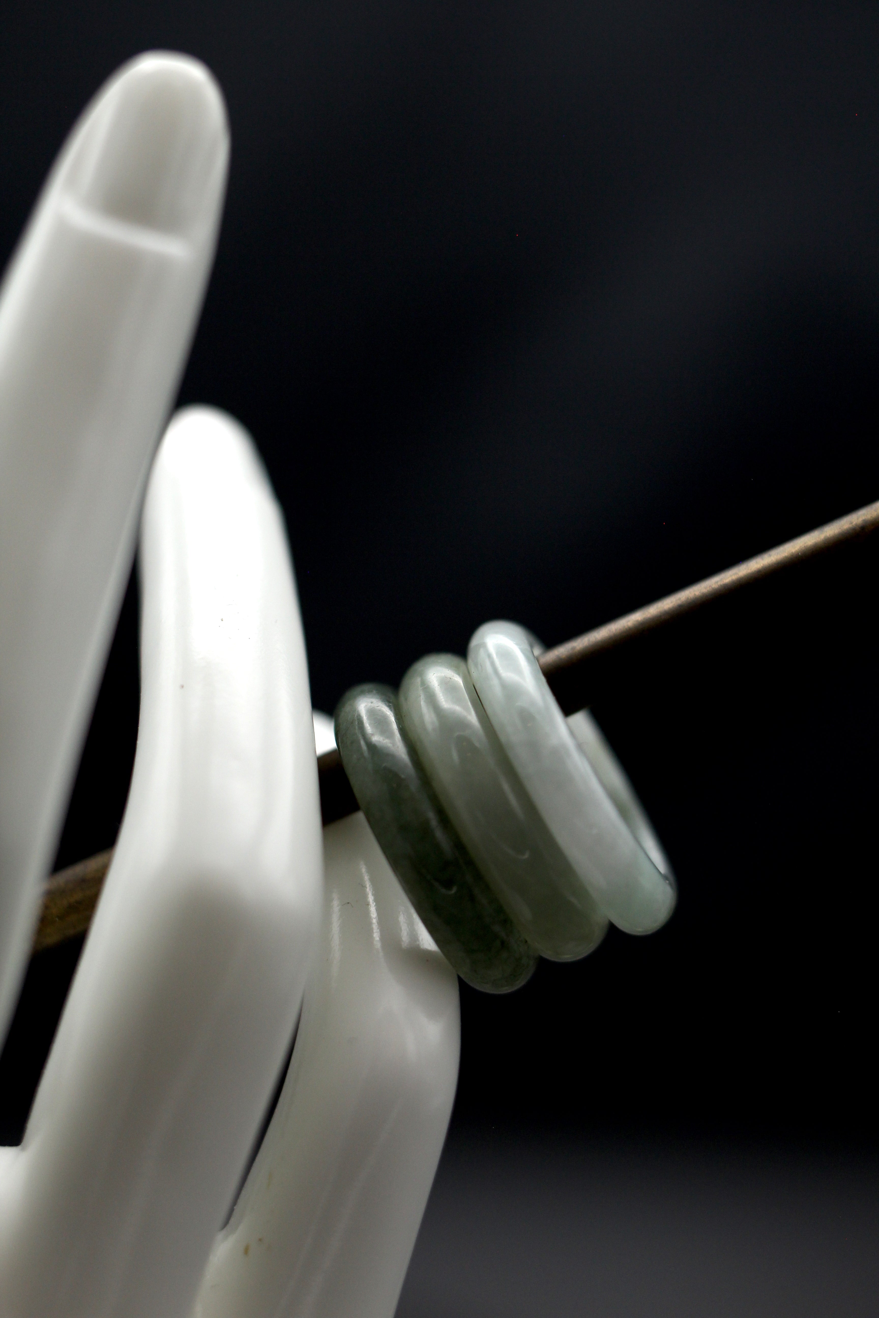three beautiful jade rings lightest to darkest right to left