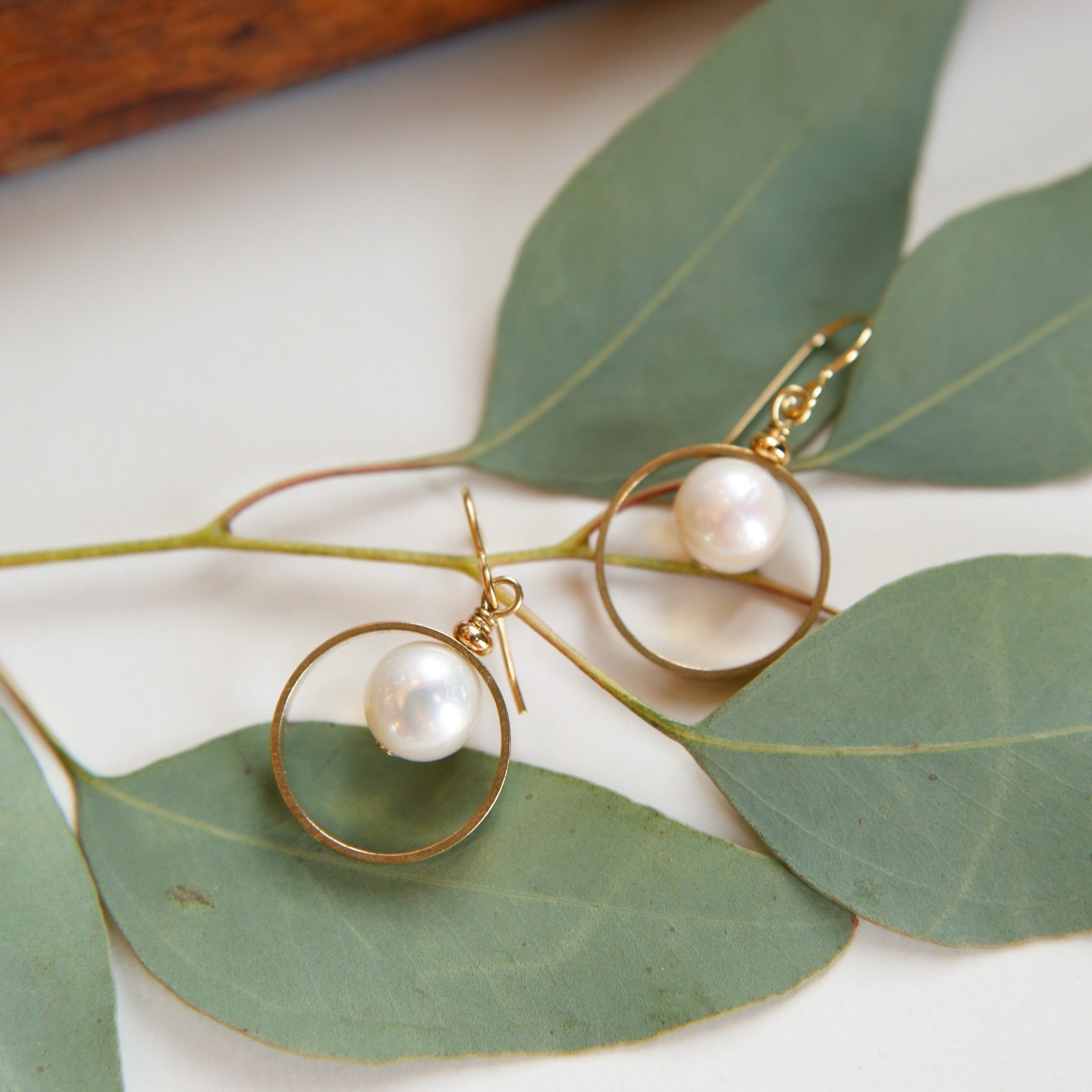 Classic pearl earrings by Cival collective with brass halo ring. Simple wedding jewelry designs that make the perfect gifts for bridesmaids.