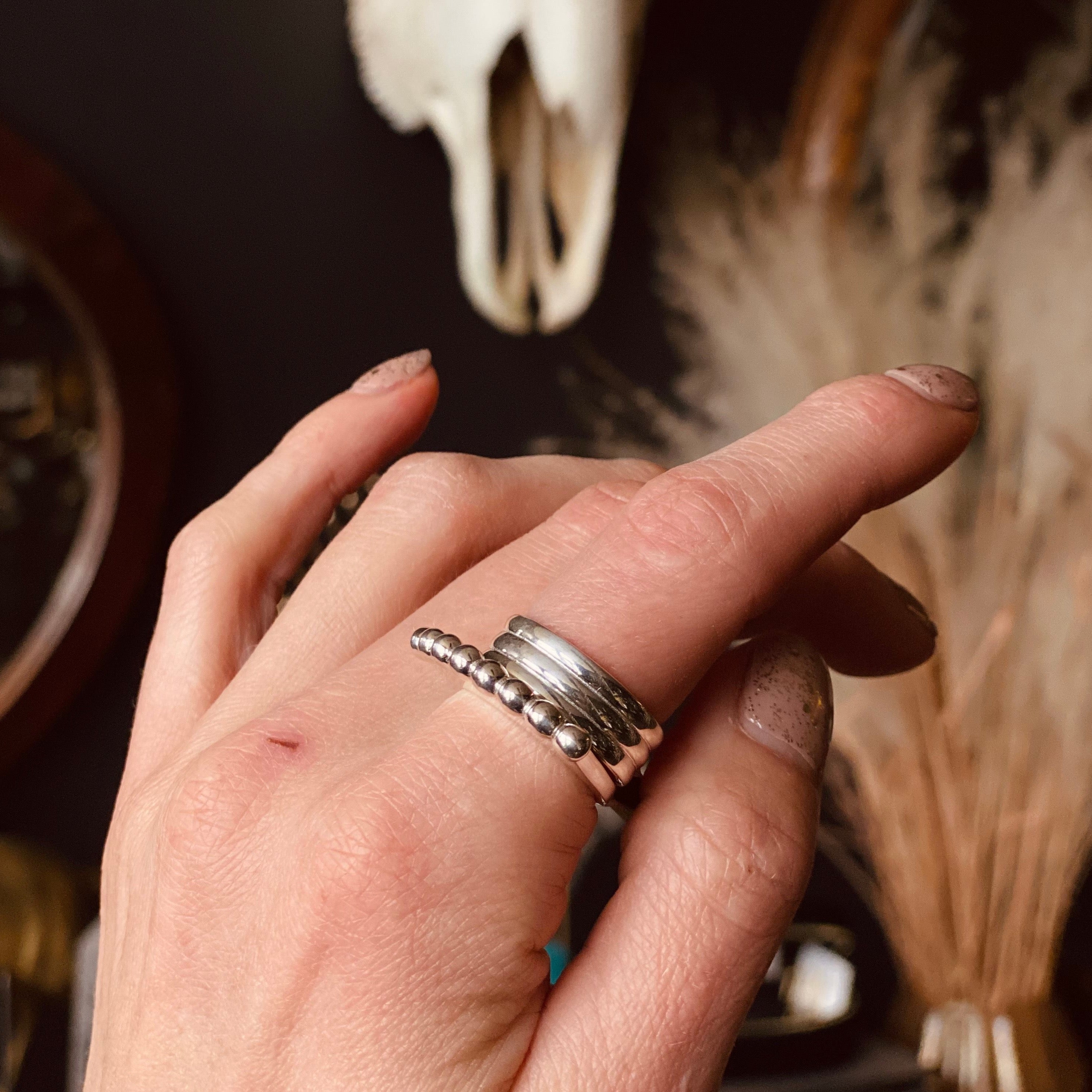 Sterling silver band with three striped sections beautifully stacked on finger