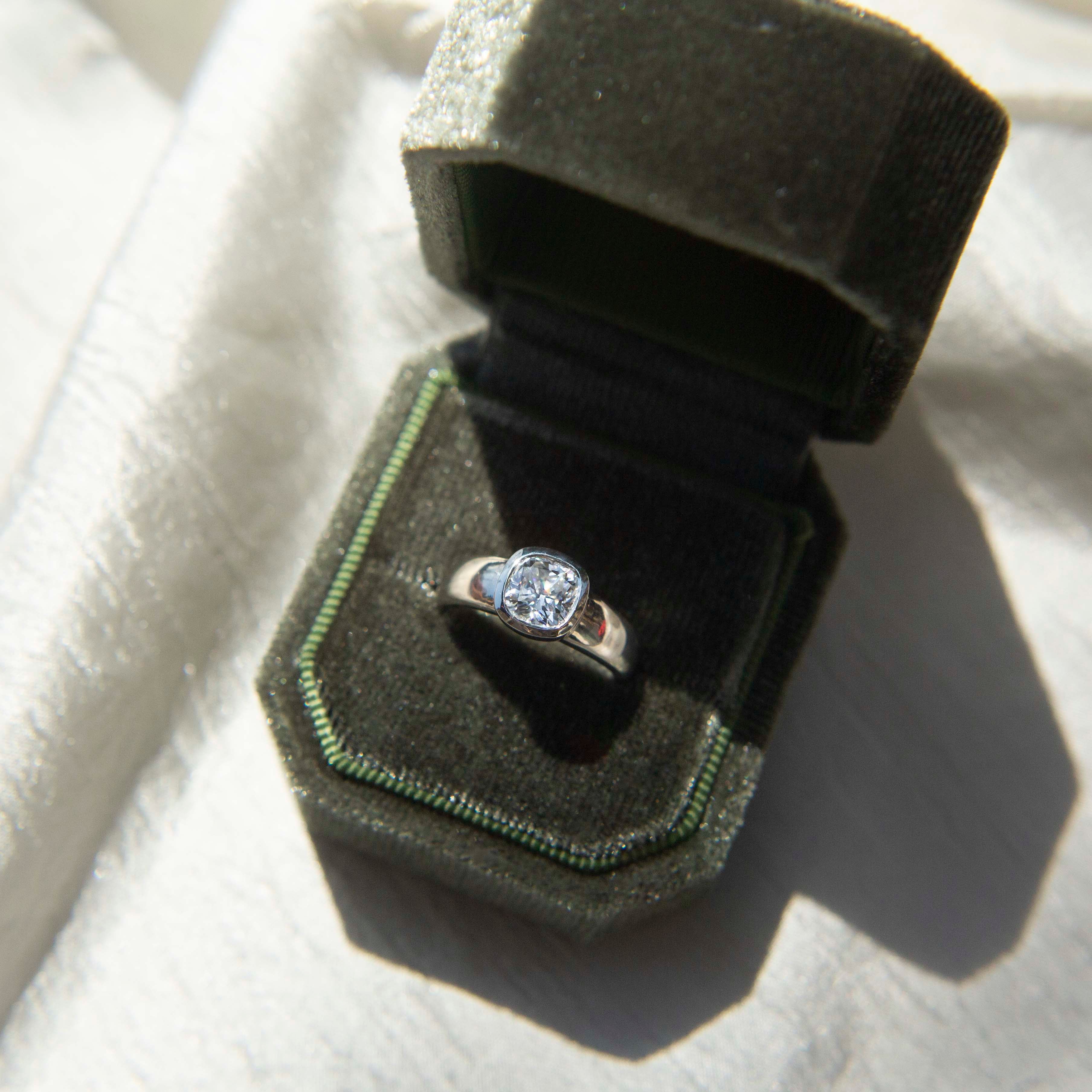 gold ring with a bezel set diamond. This solitaire engagement ring can be made with your desired stone type (Diamond, moissanite, sapphire etc.) and stone shape (Square, Marquis, round, emerald, assher, etc.) and in your choice of metal! (10k yellow or white gold, 14k yellow or white gold, 18k yellow or white gold, platinum and continuum silver.)