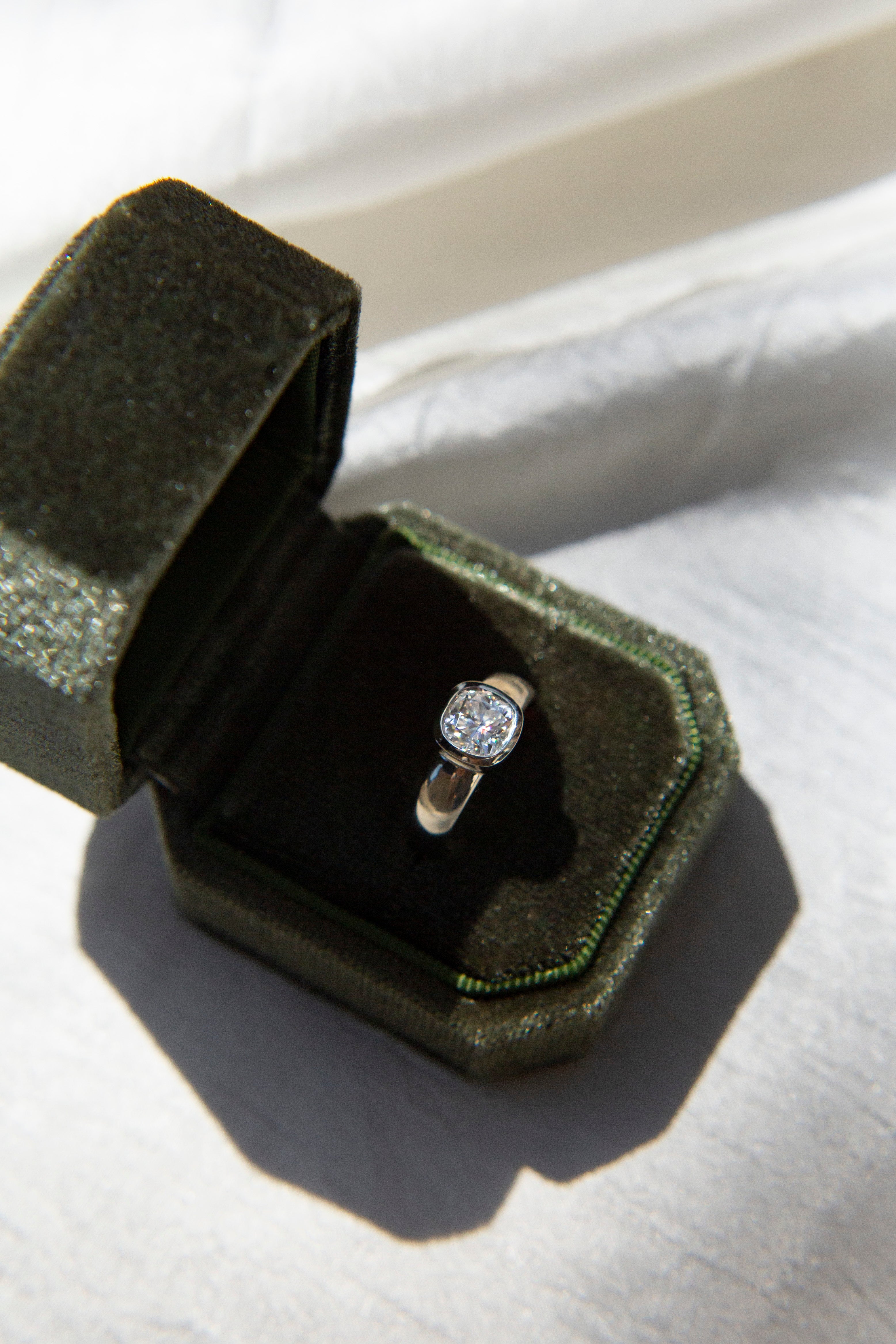 gold ring with a bezel set diamond. This solitaire engagement ring can be made with your desired stone type (Diamond, moissanite, sapphire etc.) and stone shape (Square, Marquis, round, emerald, assher, etc.) and in your choice of metal! (10k yellow or white gold, 14k yellow or white gold, 18k yellow or white gold, platinum and continuum silver.)