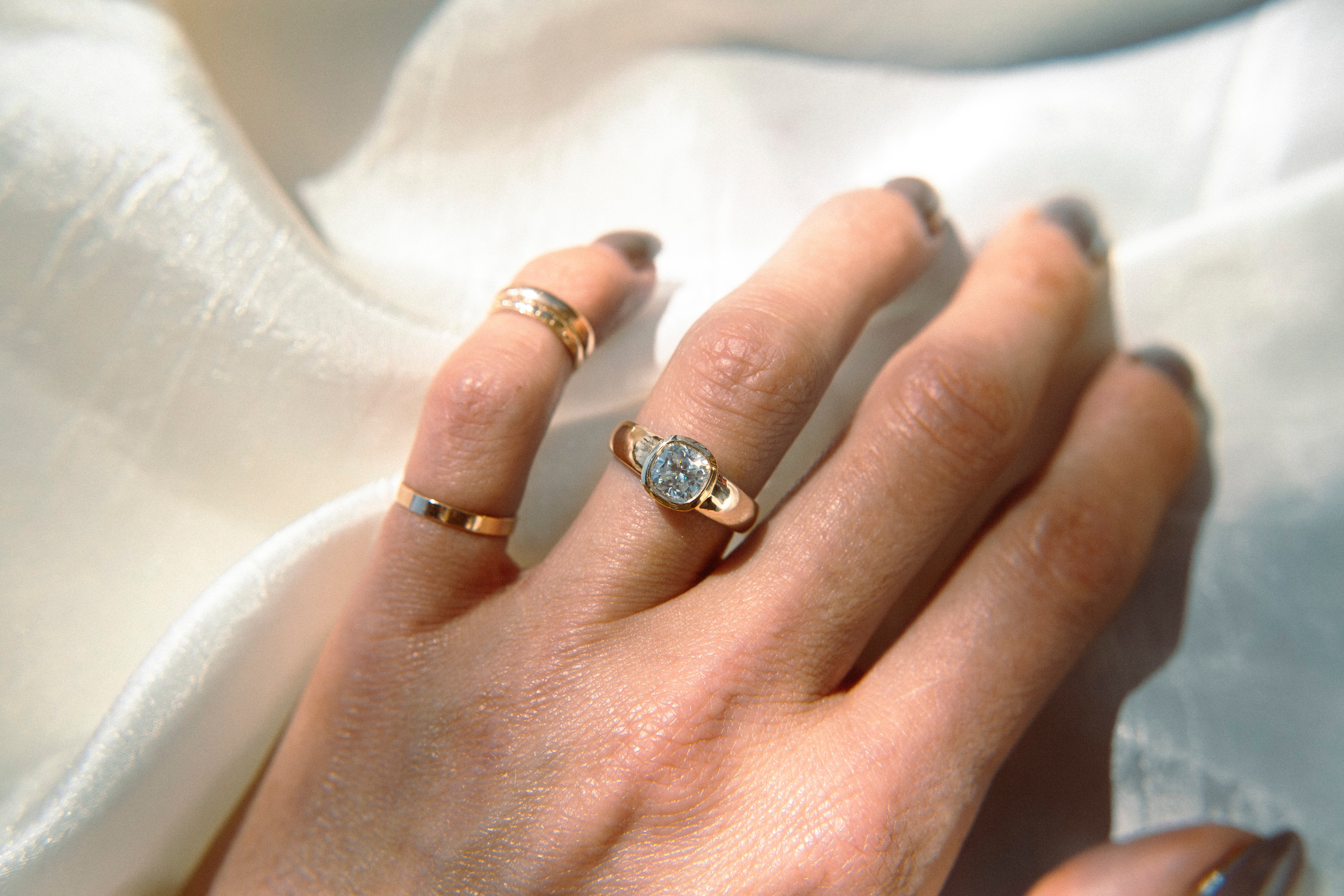gold ring with a bezel set diamond. This solitaire engagement ring can be made with your desired stone type (Diamond, moissanite, sapphire etc.) and stone shape (Square, Marquis, round, emerald, assher, etc.) and in your choice of metal! (10k yellow or white gold, 14k yellow or white gold, 18k yellow or white gold, platinum and continuum silver.)