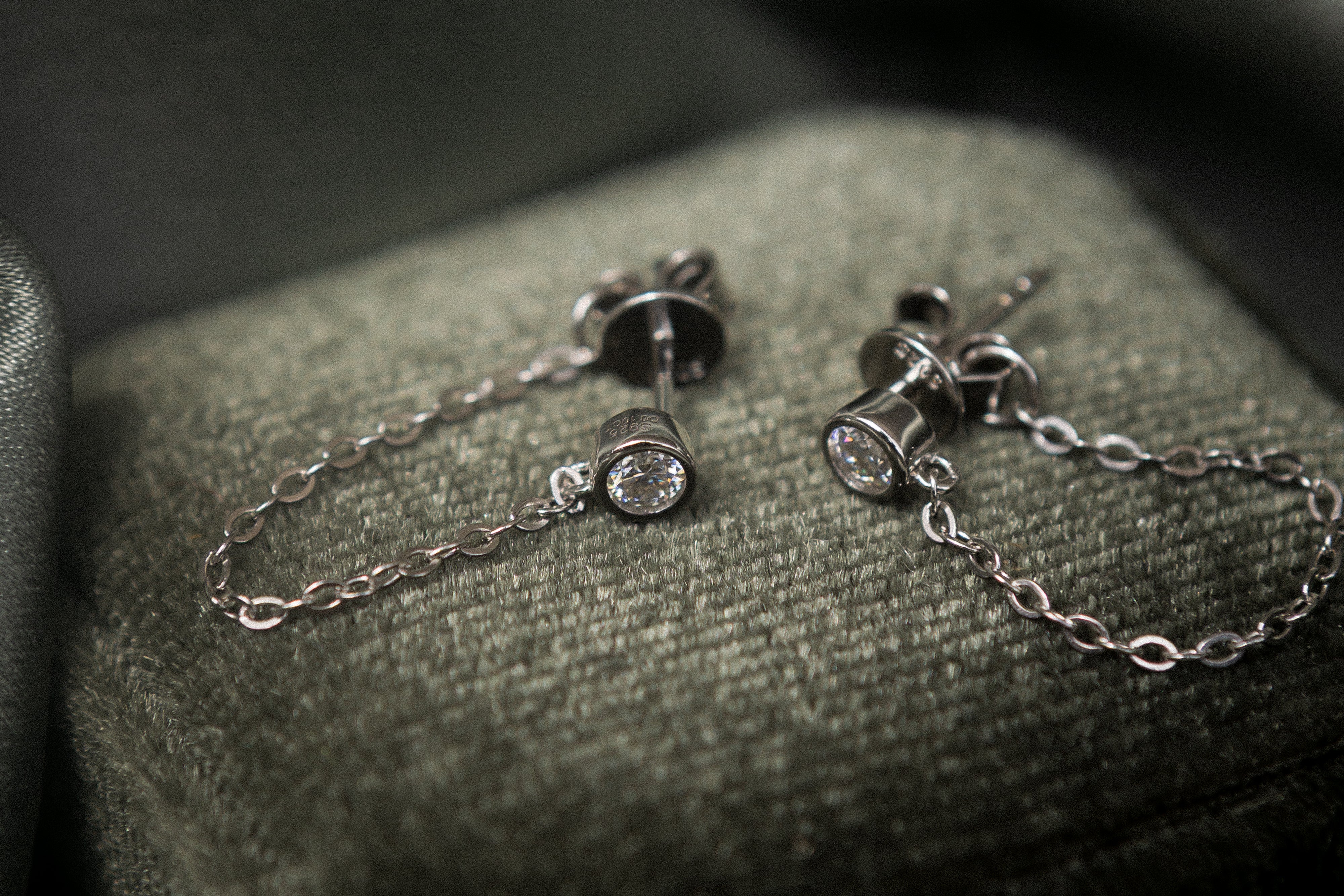 White gold filled moissanite studs with a chain that connects from front to back. Sold by cival in bayview Milwaukee wisconsin