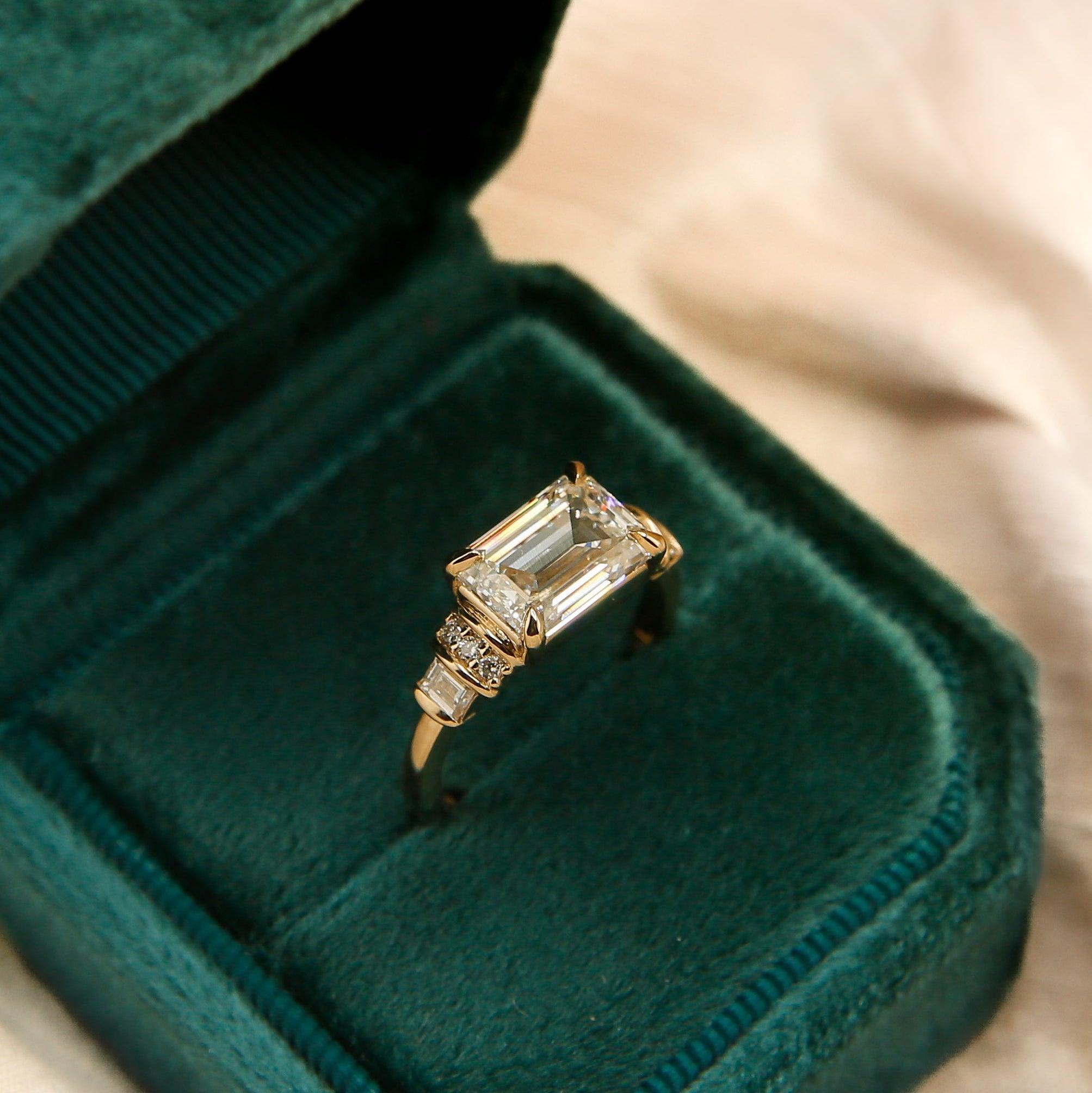 art deco emerald cut east west set diamond engagement ring 