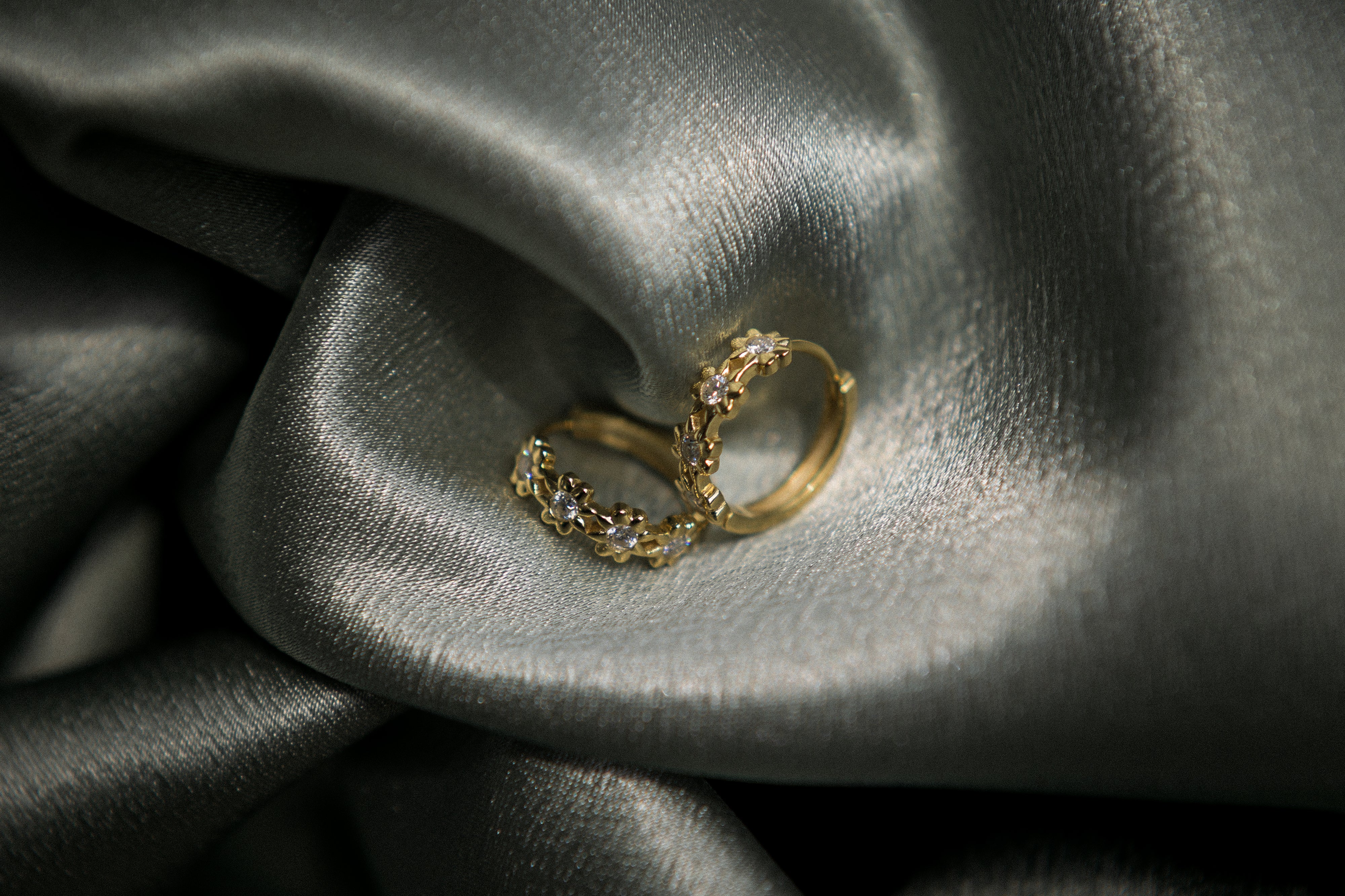 Yellow gold vermeil hoops with floral detailing and moissanite centers. Perfect demi fine gift or everyday wear. Sold by Cival in milwaukees bayview