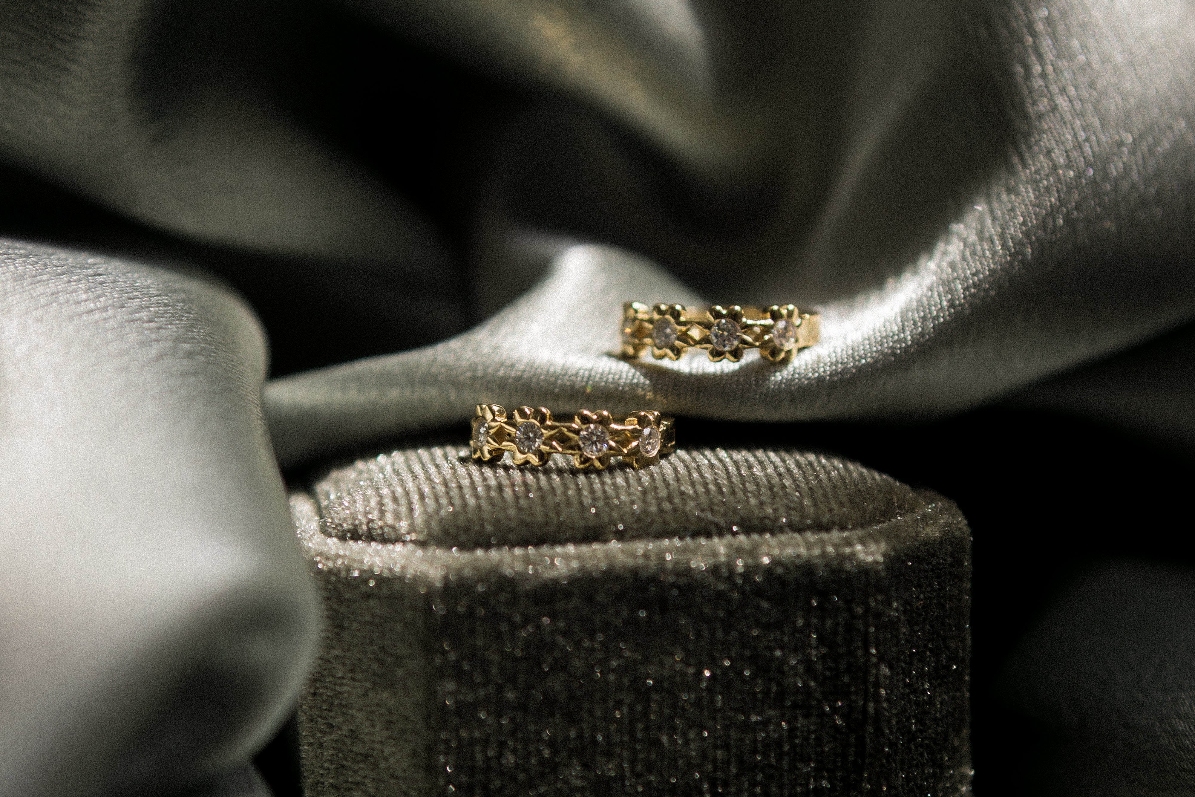 Yellow gold vermeil hoops with floral detailing and moissanite centers. Perfect demi fine gift or everyday wear. Sold by Cival in milwaukees bayview