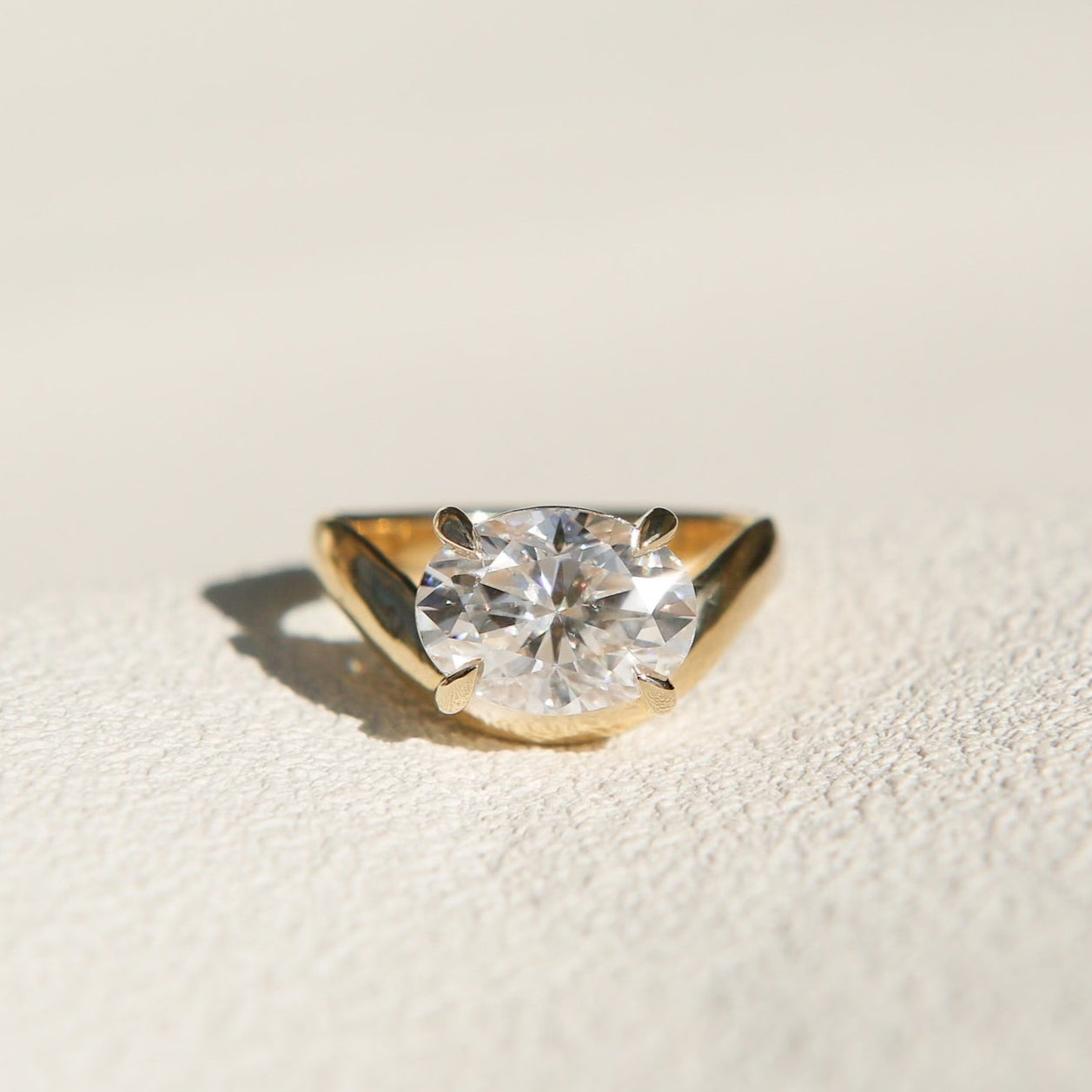 Hydra wave band in 14k yellow gold with a beautiful oval diamond and 4 claw prongs perfect for an engagement or wedding