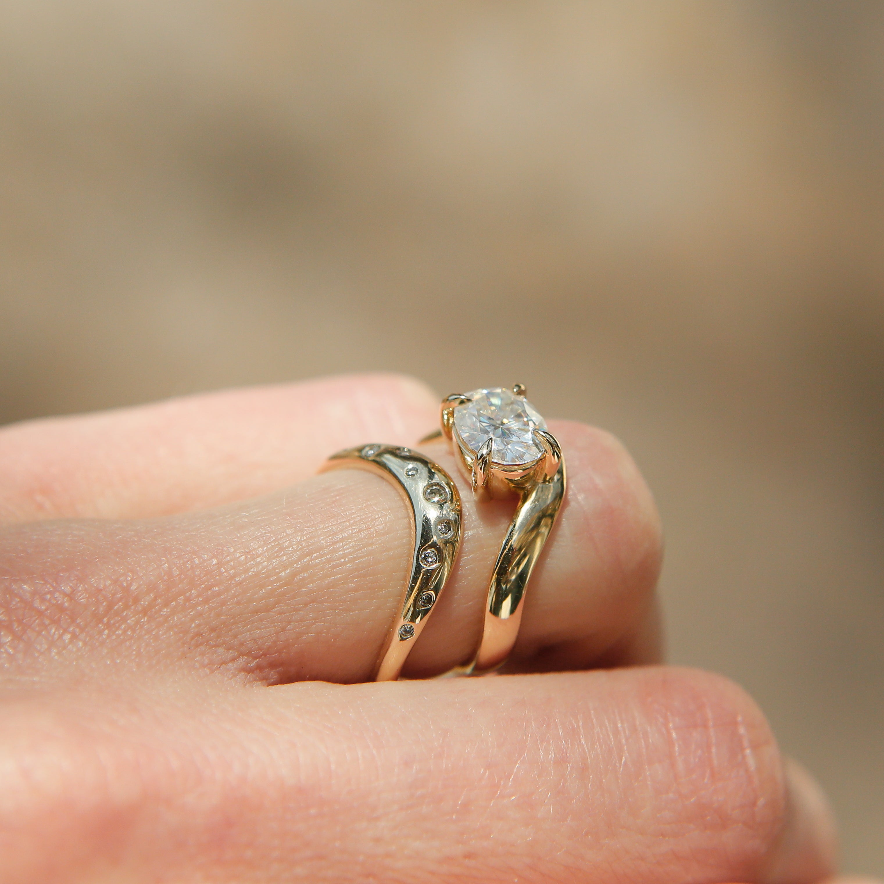 Hydra wave band in 14k yellow gold with a beautiful oval diamond and 4 claw prongs perfect for an engagement or wedding