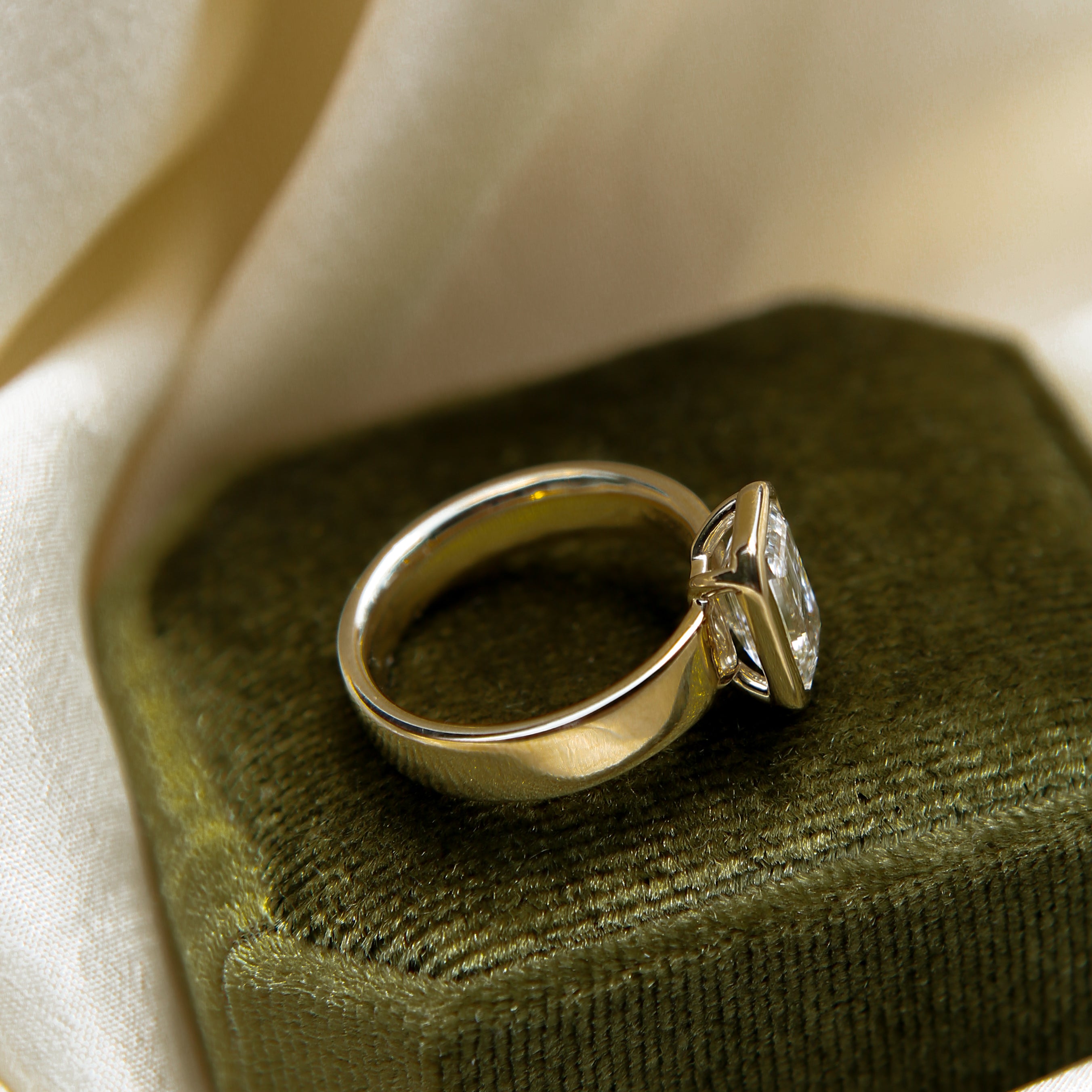 Wide band engagement ring in 14k with a open bezel set stone. Customize this unique ring with your choice of stone type, stone shape and stone size. Diamond, moissanite, round, oval, princess, cushion, asscher, marquise. Cival in Milwaukee Wisconsin. 