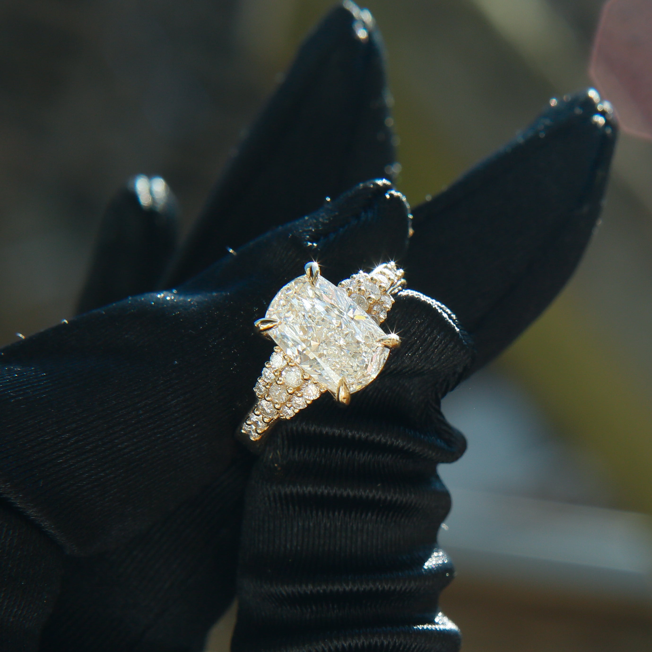 Diamond ring on a black glove with a blurred background