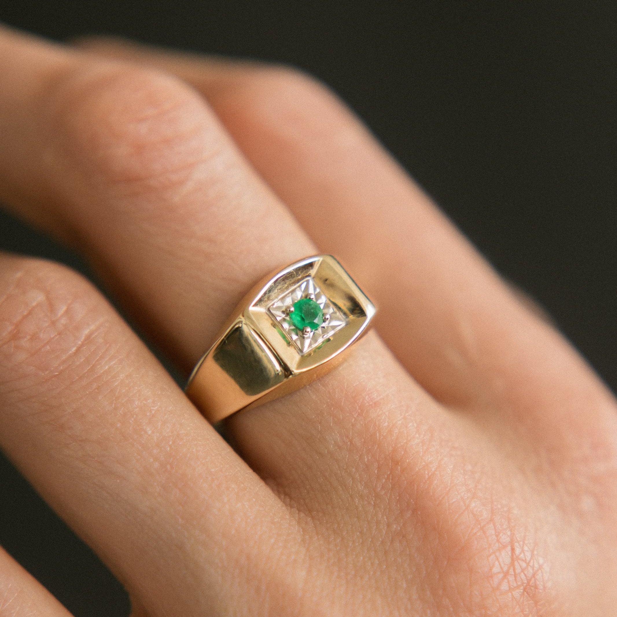 two tone ring on hand on black background