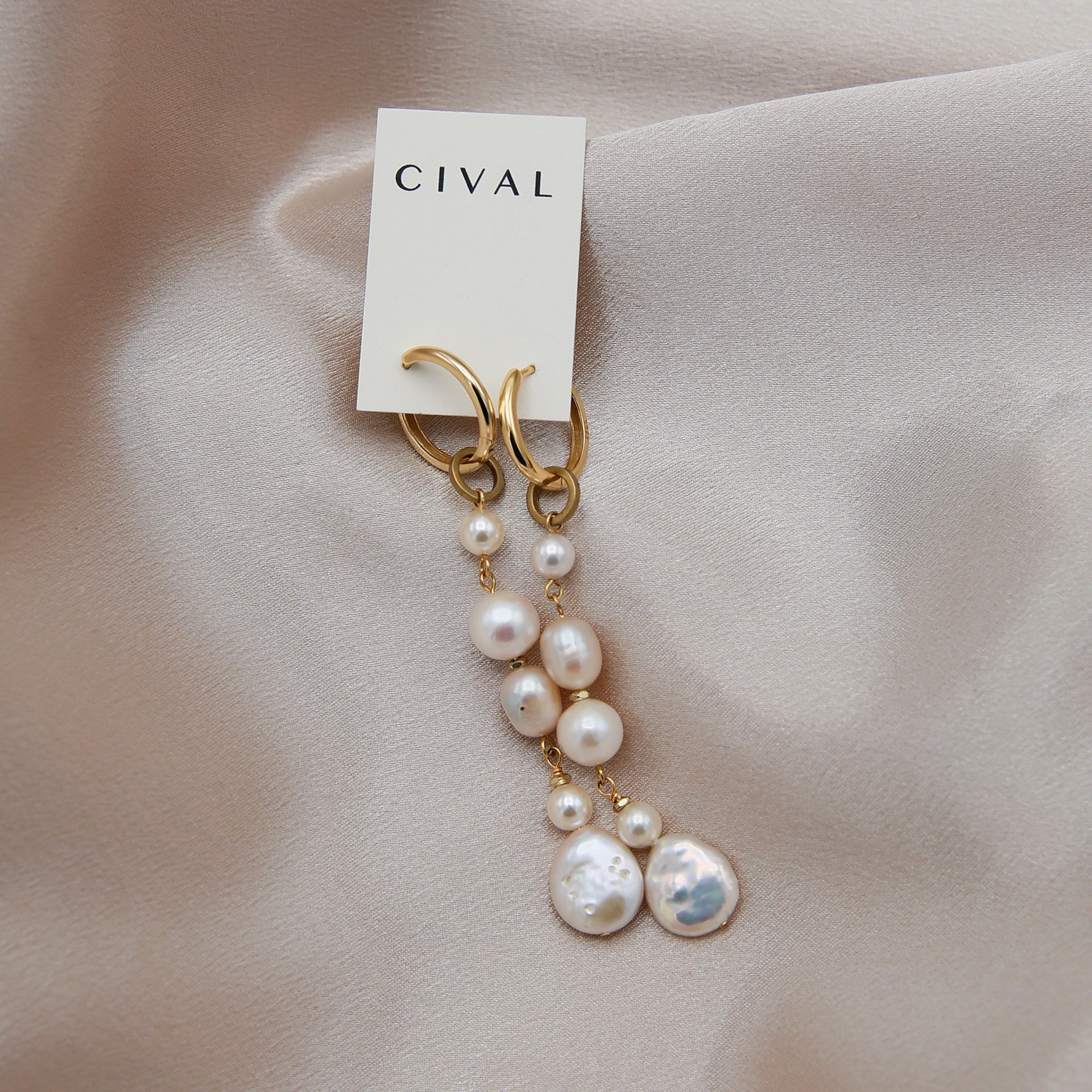 close up of lindsay hoops with pearls suspended on 14 gold plated sterling silver hoops