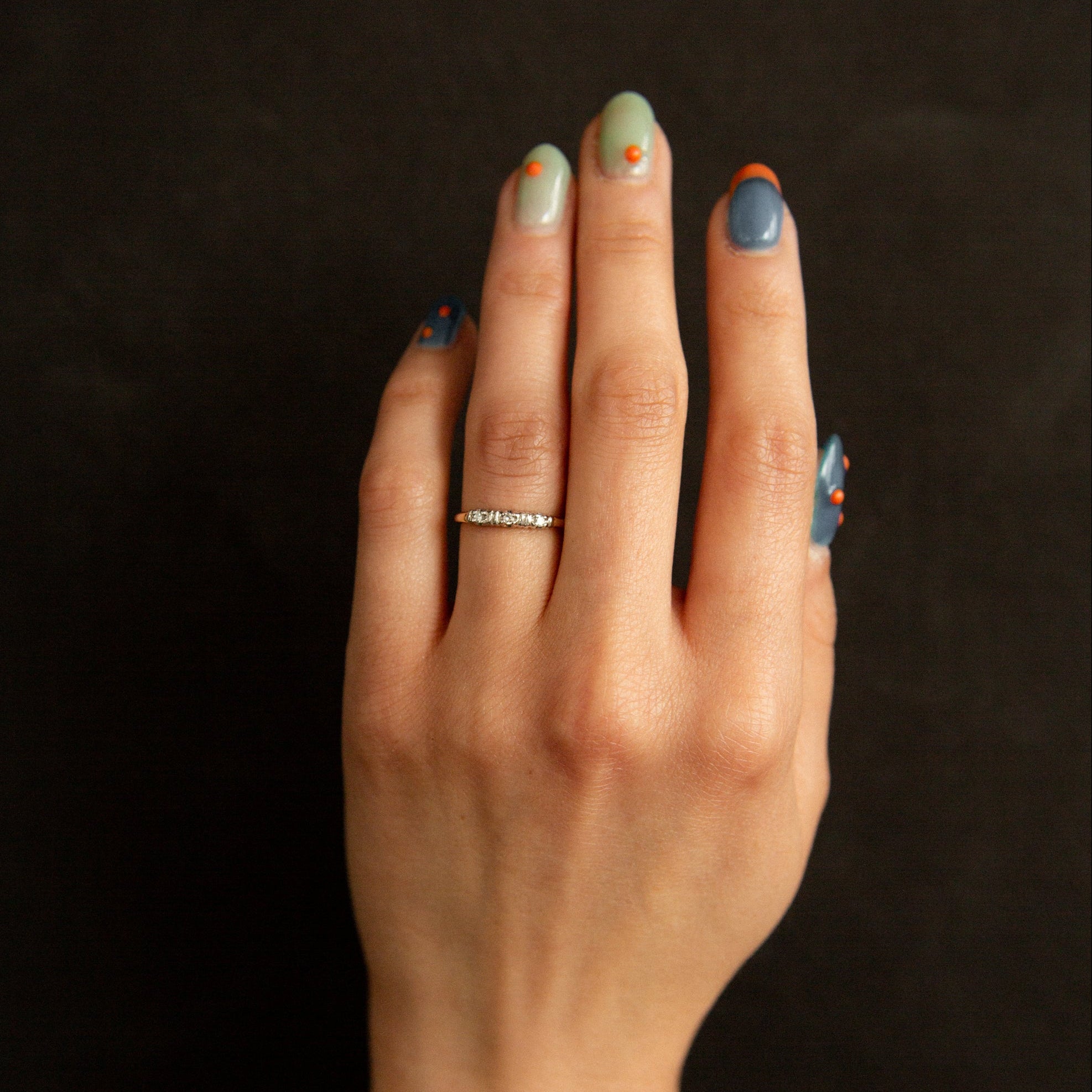 antique wedding band on hand with black background 