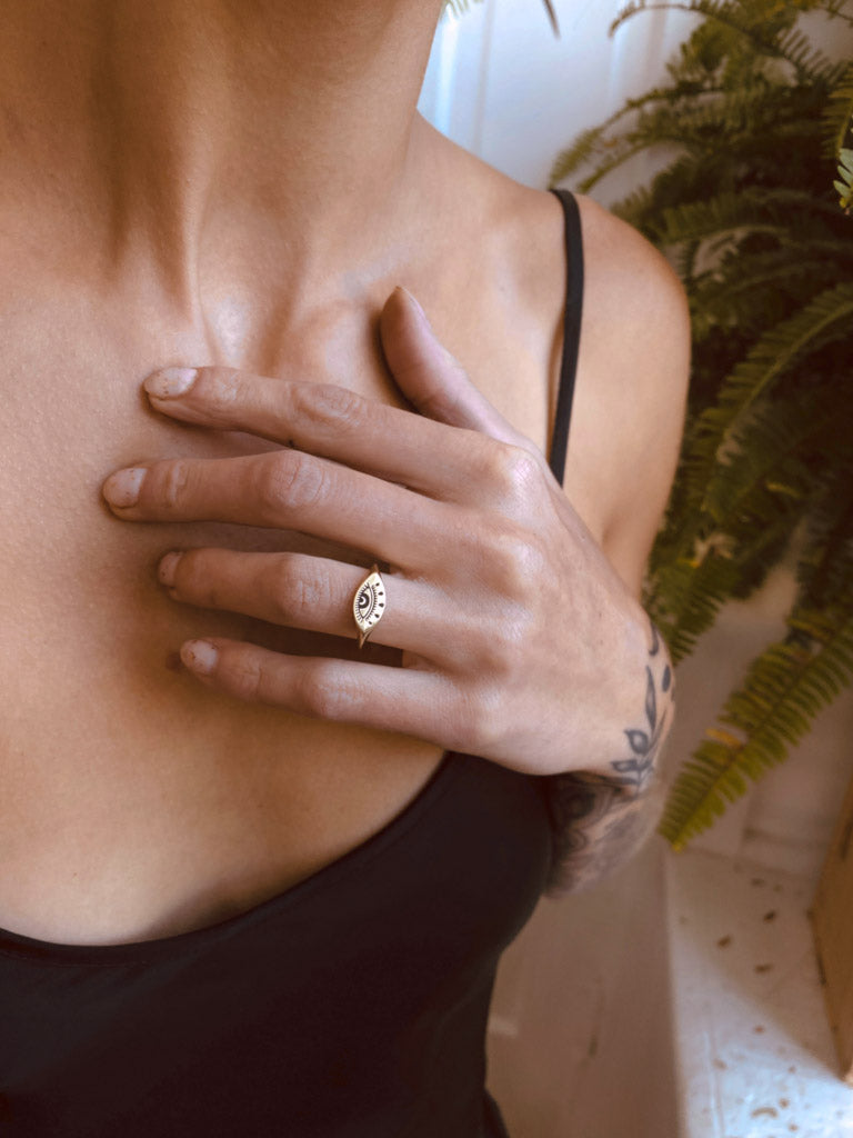 model showcasing brass evil eye ring