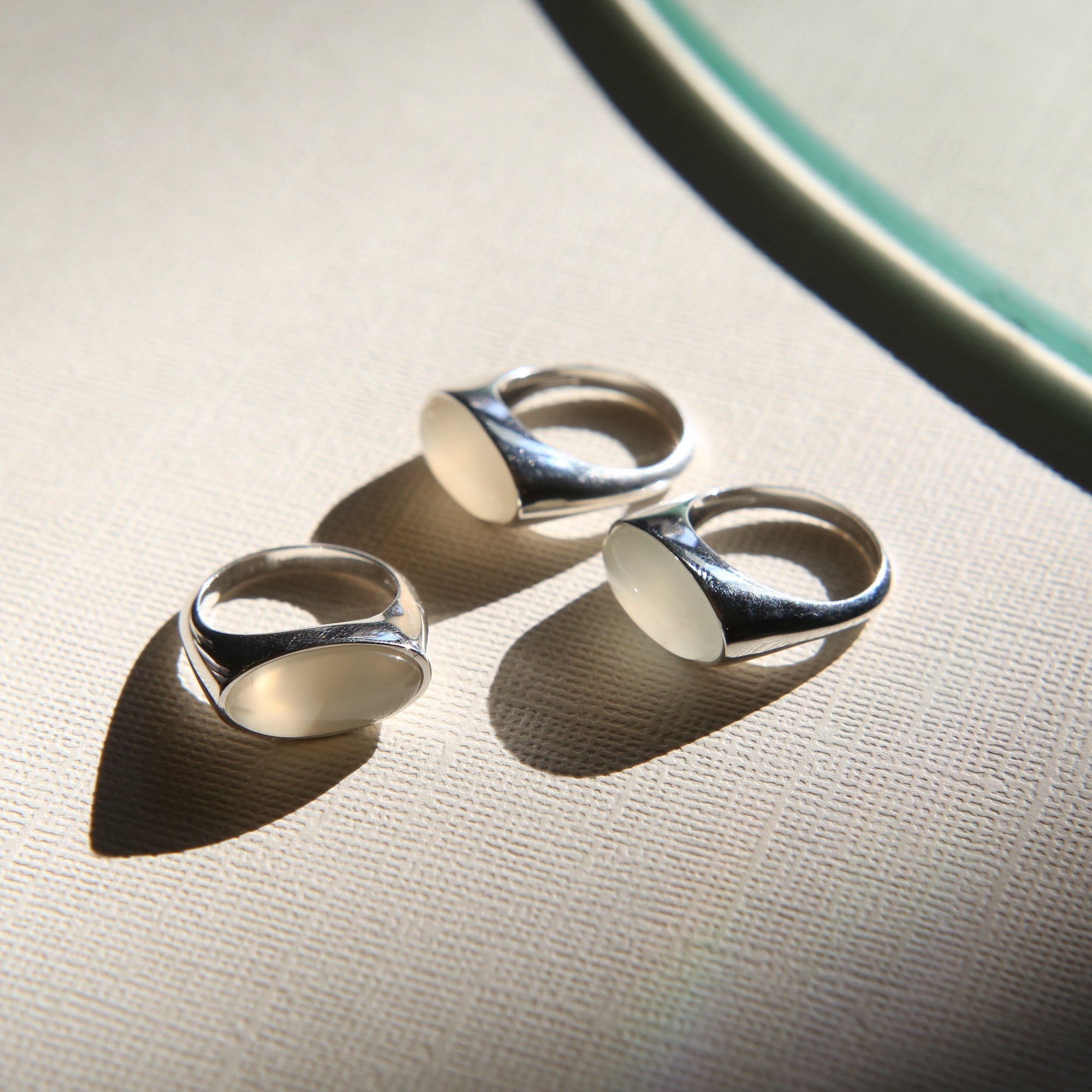 Three Sterling silver dome rings with cloudy white oval stones