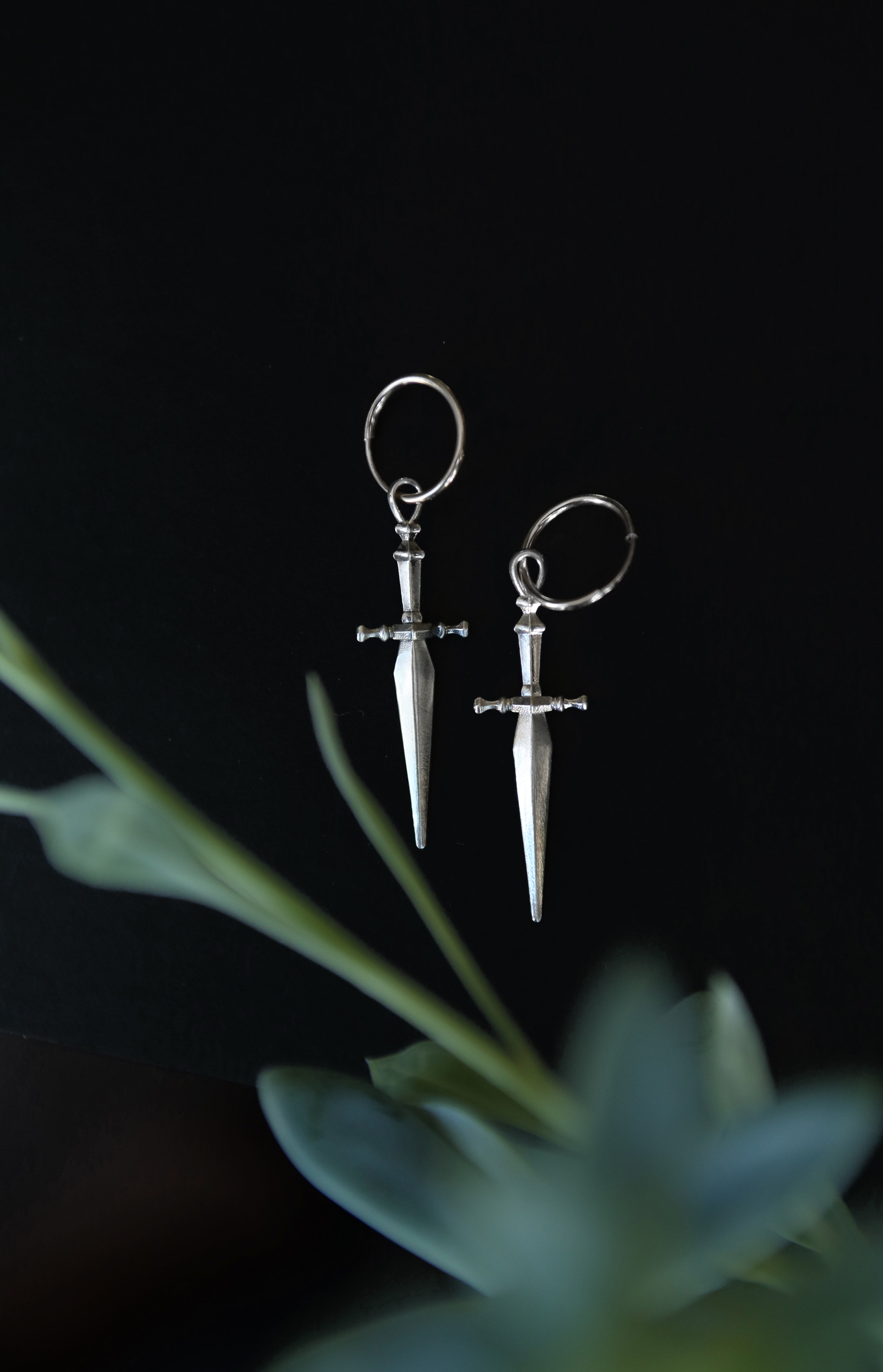 Sterling silver hoops with sword dangling from both