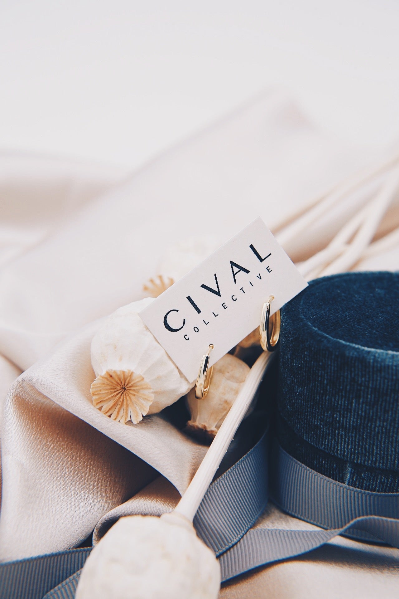 gold sunna hoop earrings on cival backing