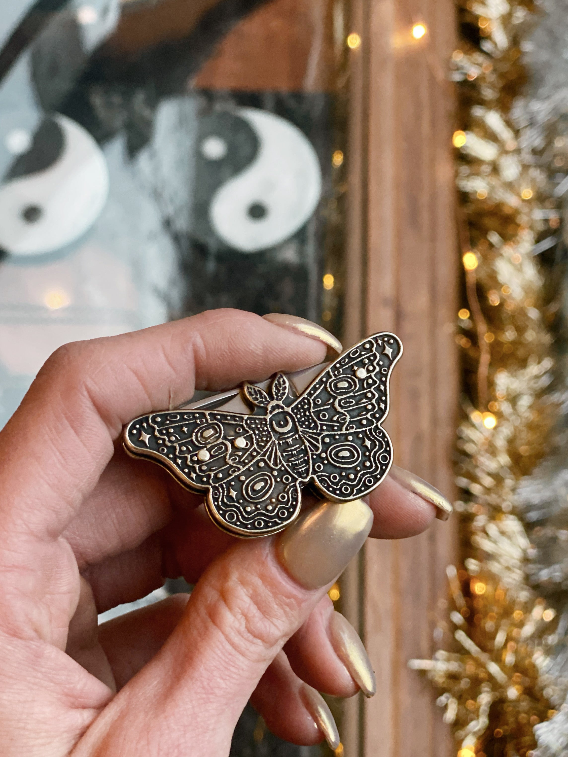 model holding moth pocket knife in hand