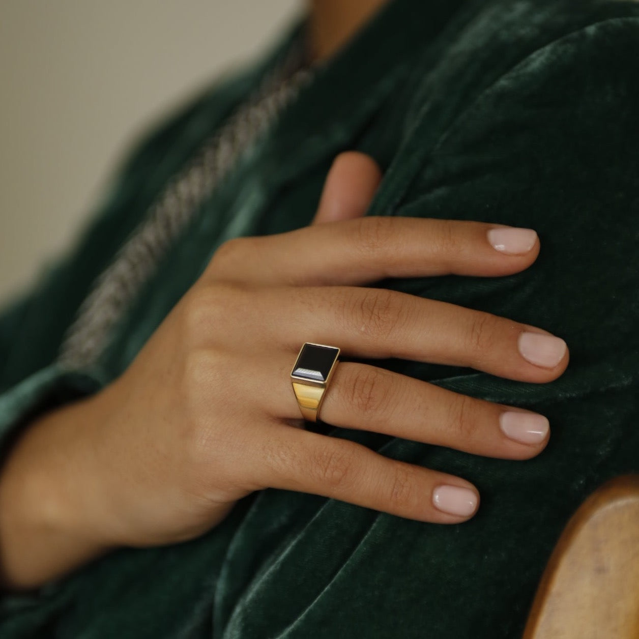 model wearing brass Velma ring with black set stone
